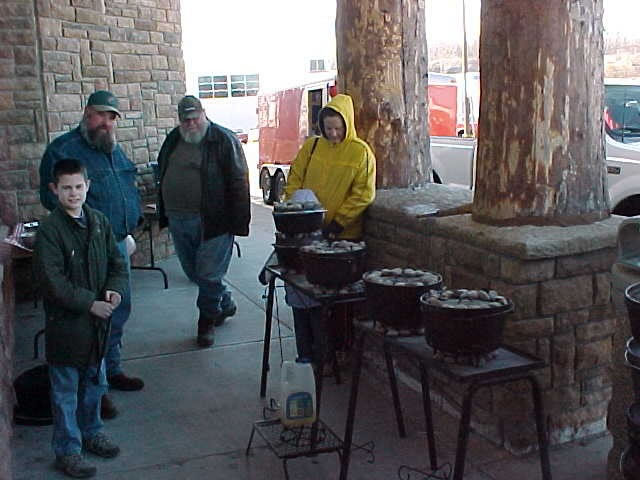 Cub Scout helped with placing charcoal